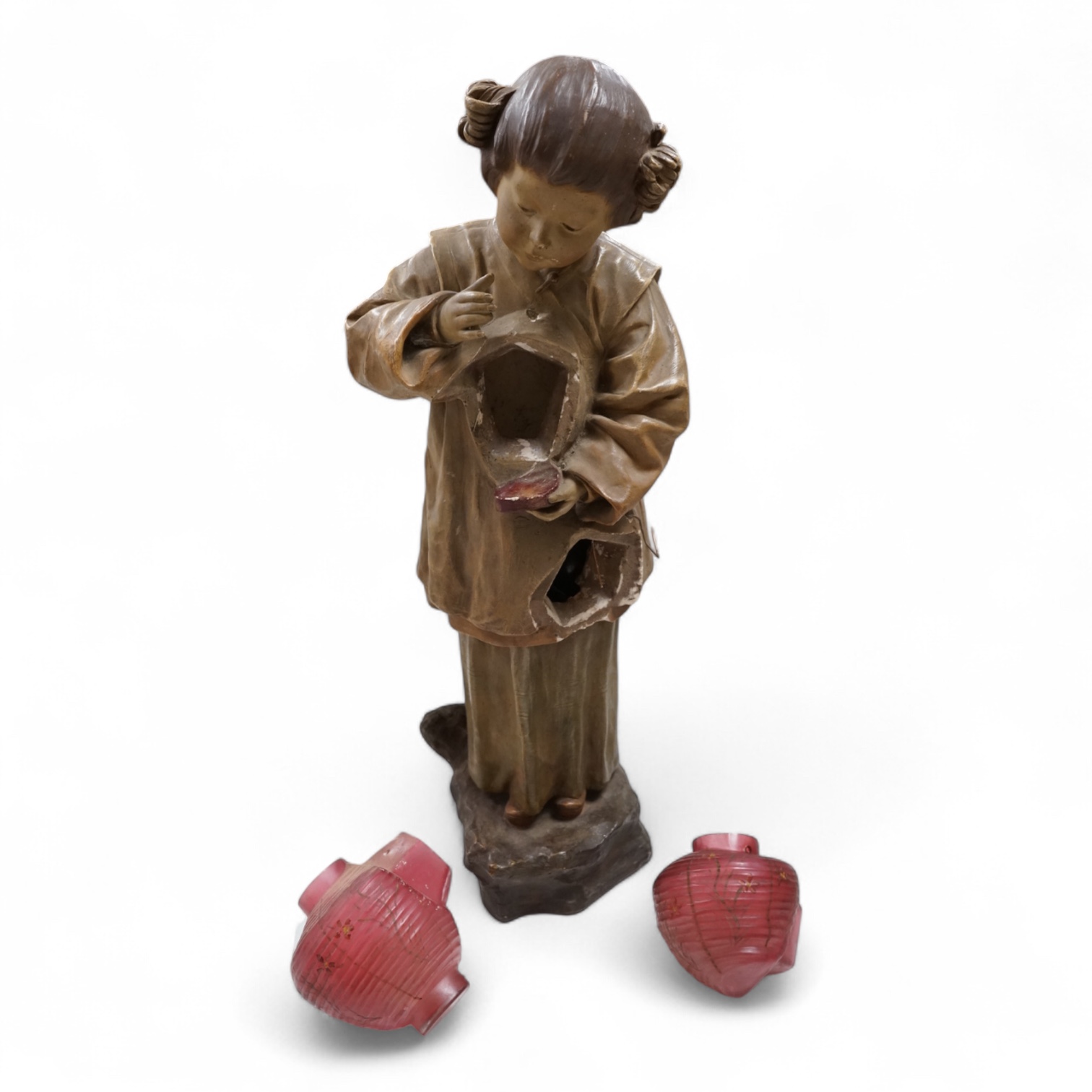 A Goldscheider cold-painted terracotta figural lamp with two cranberry glass shades, 55cm high